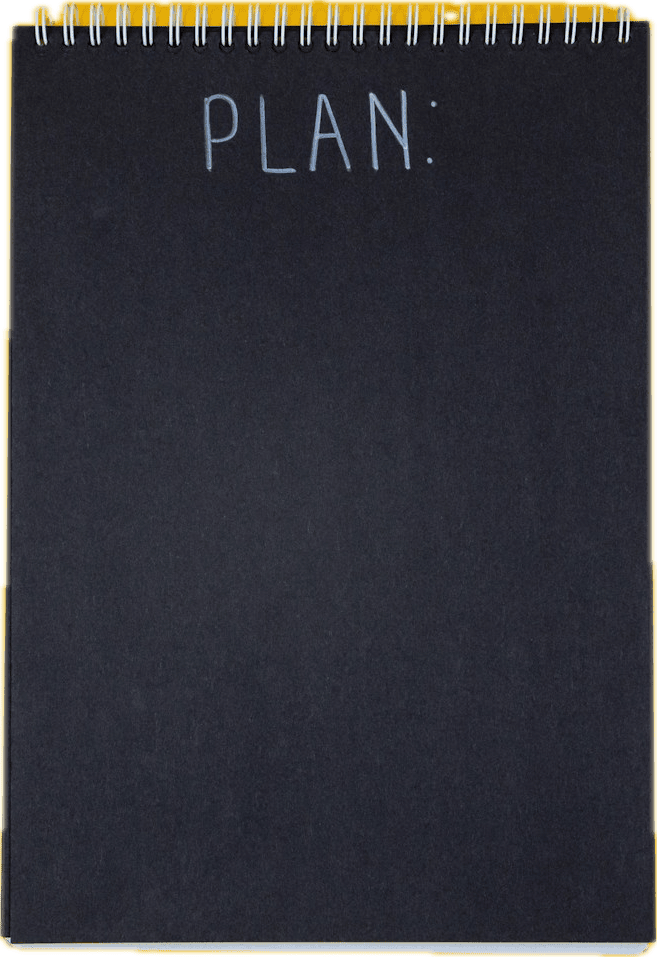 A black notebook with the word plan on the cover