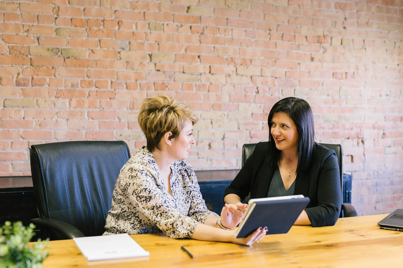 An adviser and a business owner going through figures together at a table