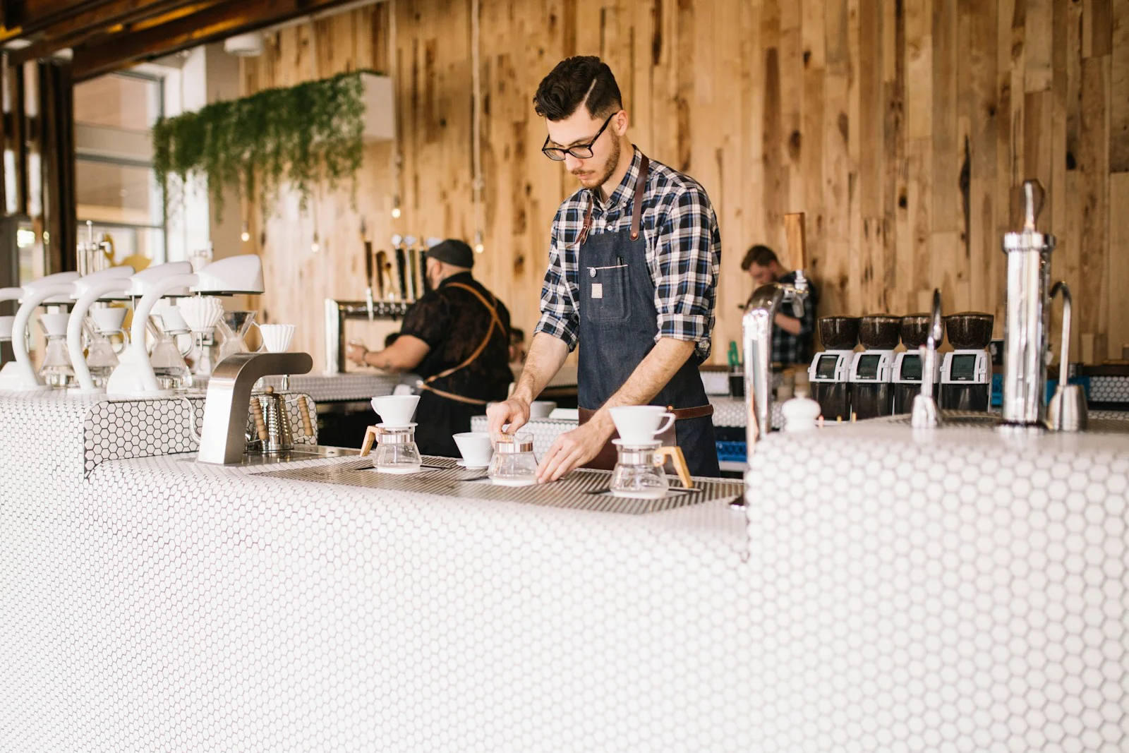 Barista preparing pour-over coffee at a cafe bar
